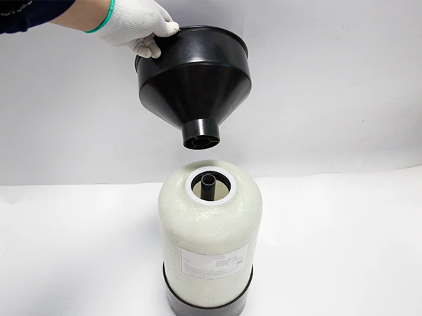 A worker is putting the PE funnel on the softener tank.